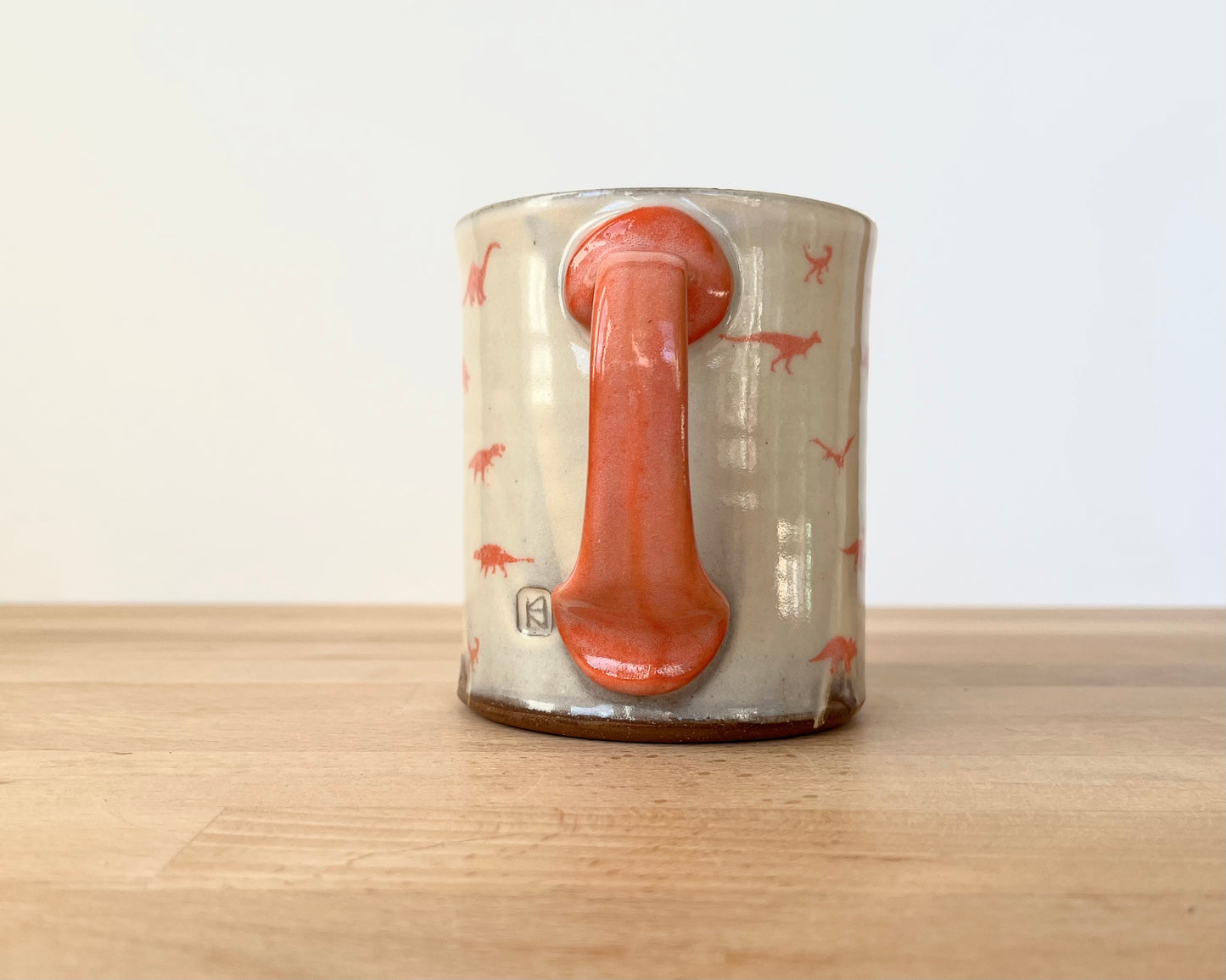Mug with small orange dinos