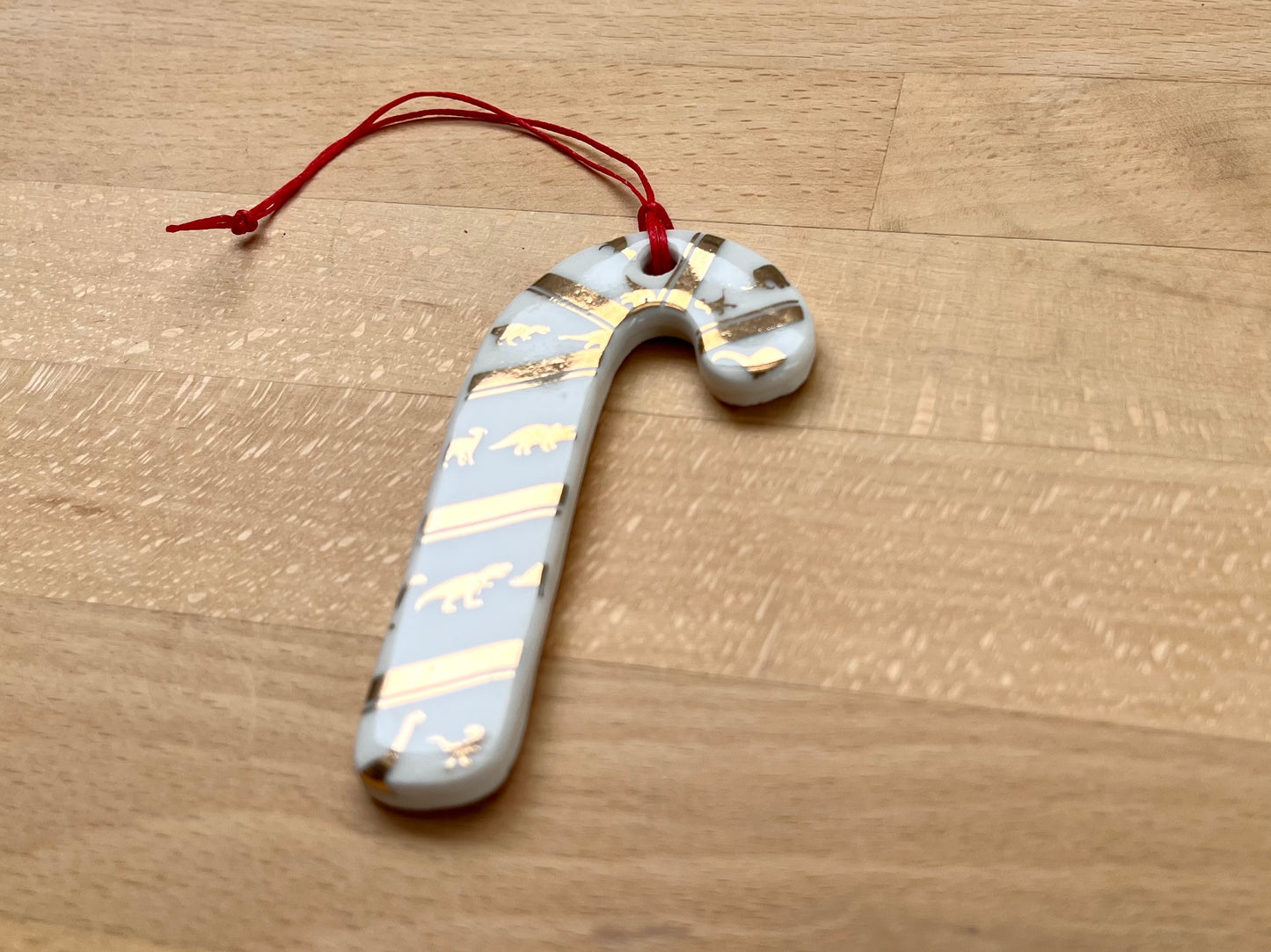 Candy cane ornament with mini dinos