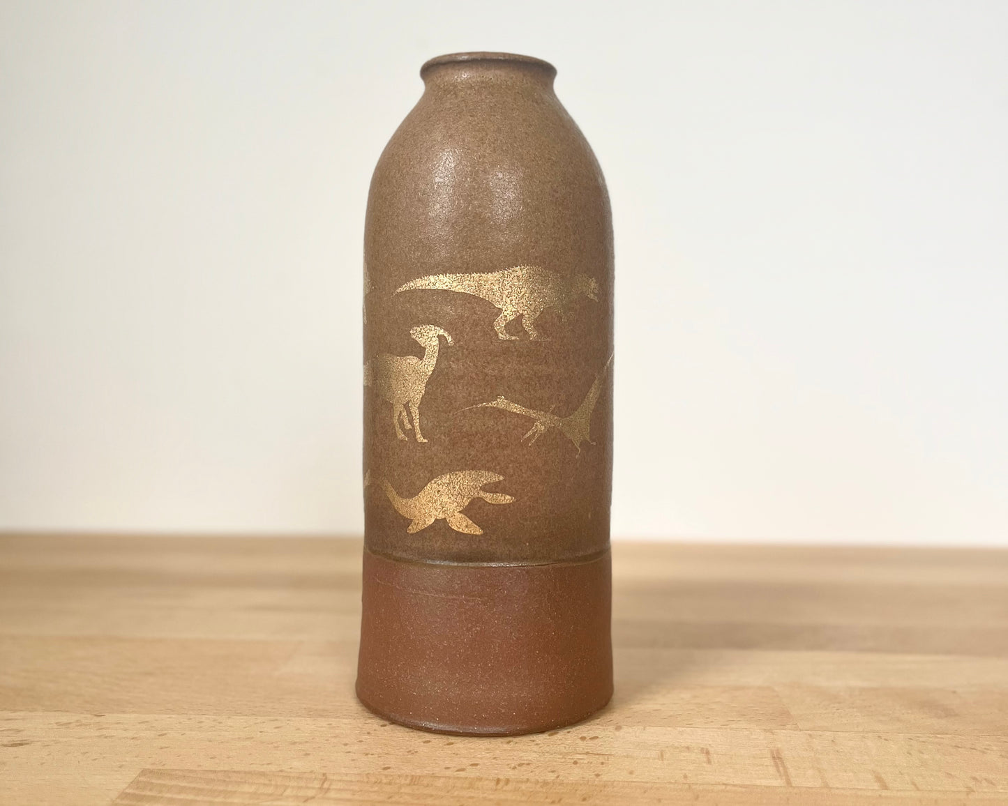 Vase with gold dinosaurs