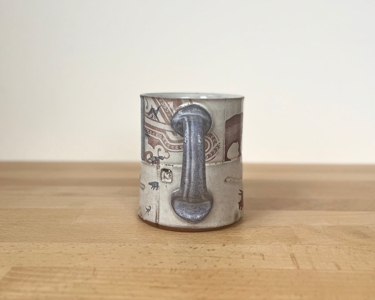 Collage mug with blue underglaze