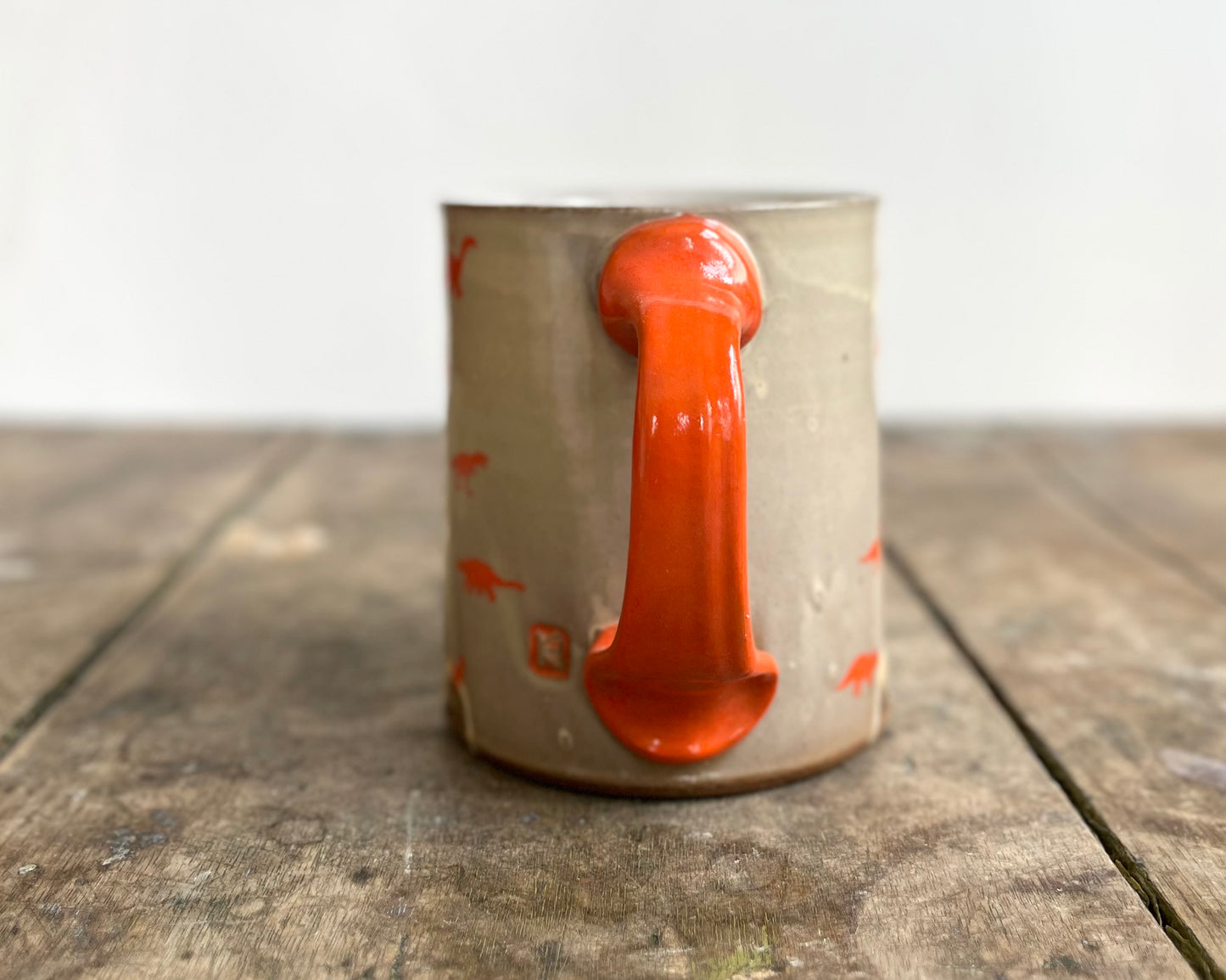Mug with orange handle and image transfer