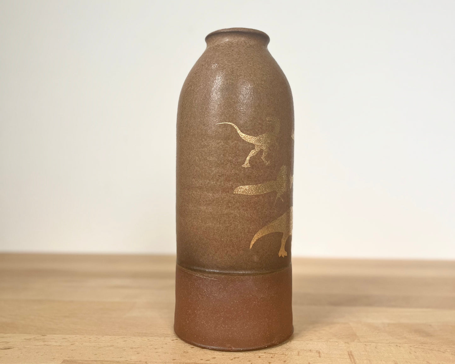 Vase with gold dinosaurs