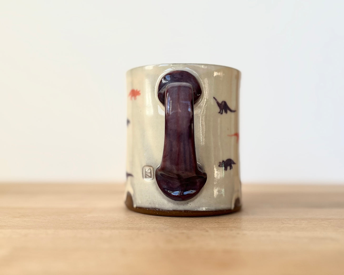 Mug with small purple and orange dinos
