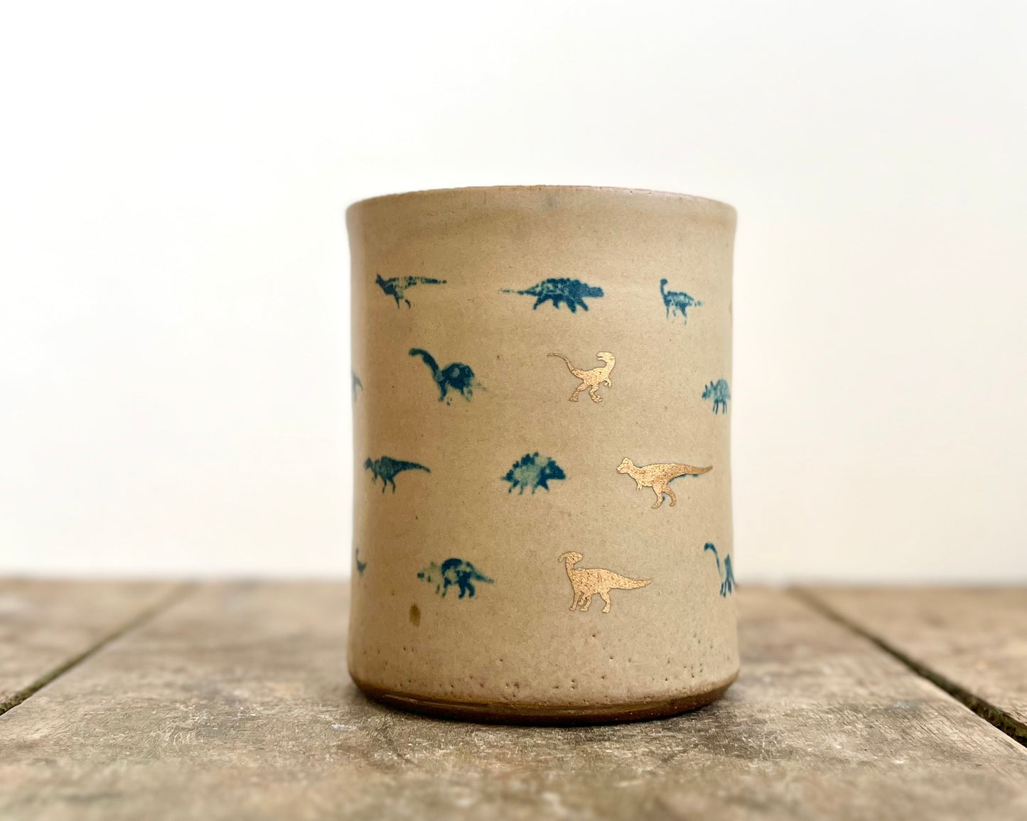 Mug with matte glaze and small blue and gold dinos