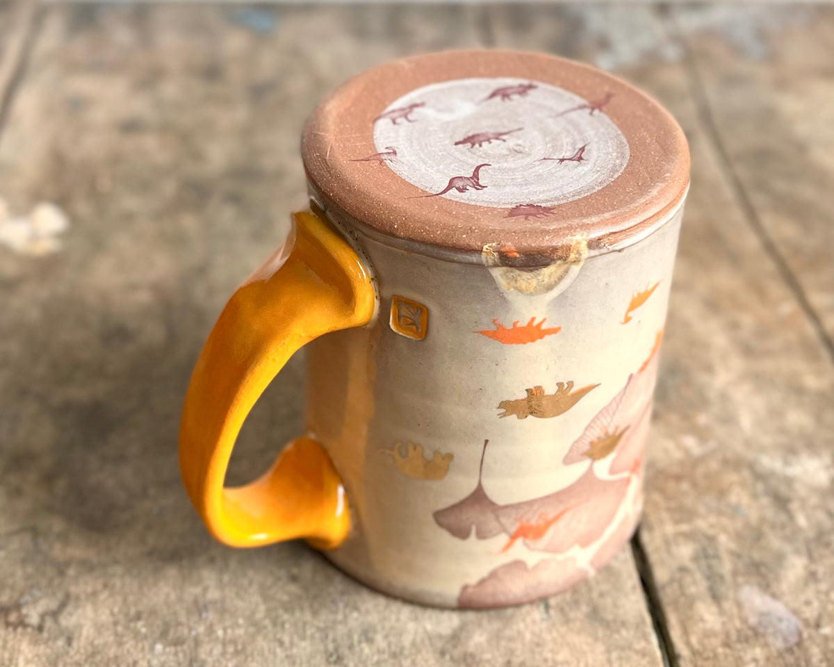 Mug with orange handle, gold decals and image transfer