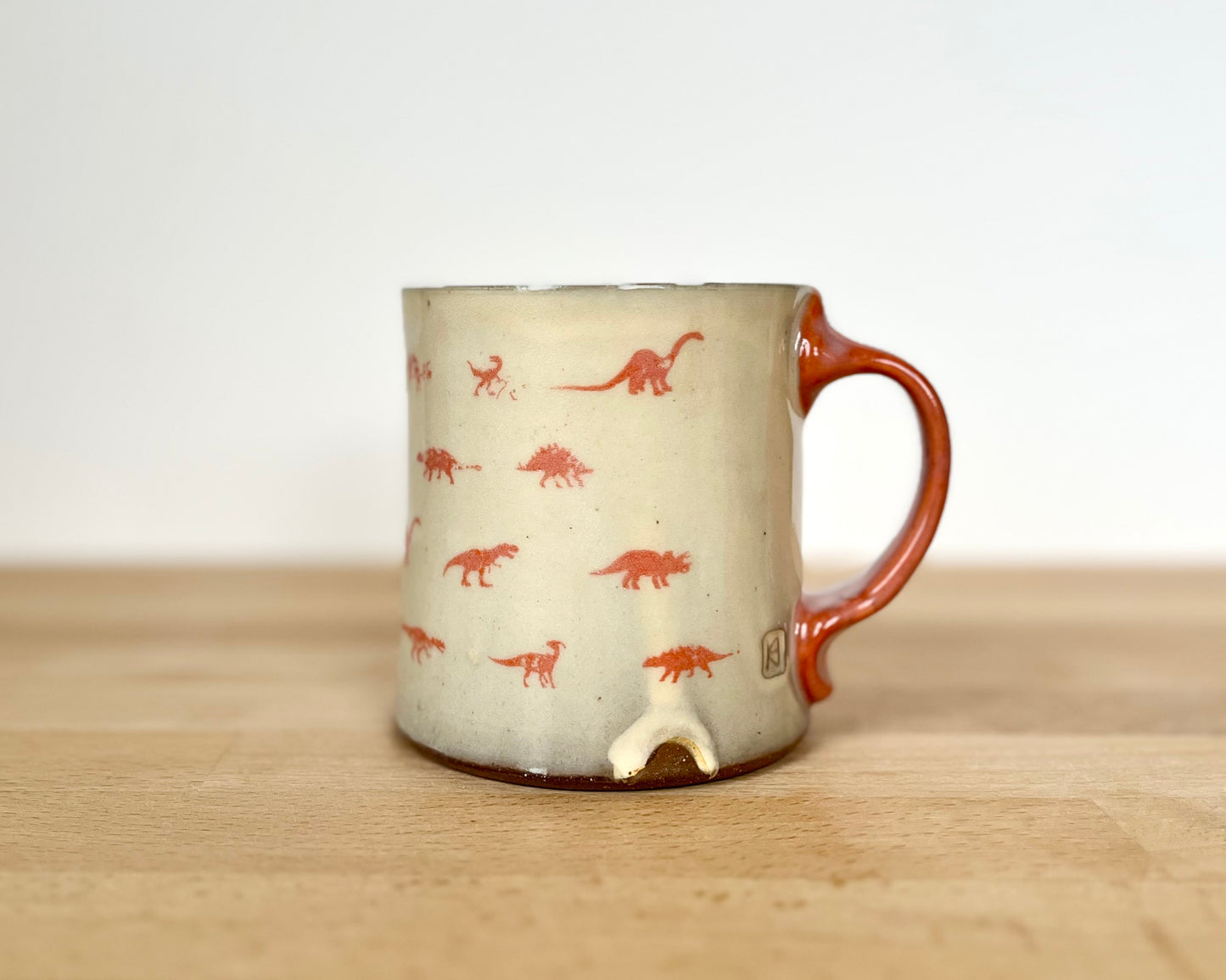 Mug with small orange dinos