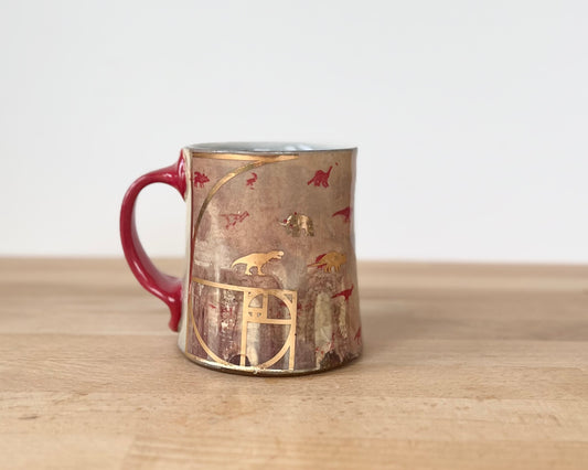 Mug with small red and gold dinos with fibonacci spiral