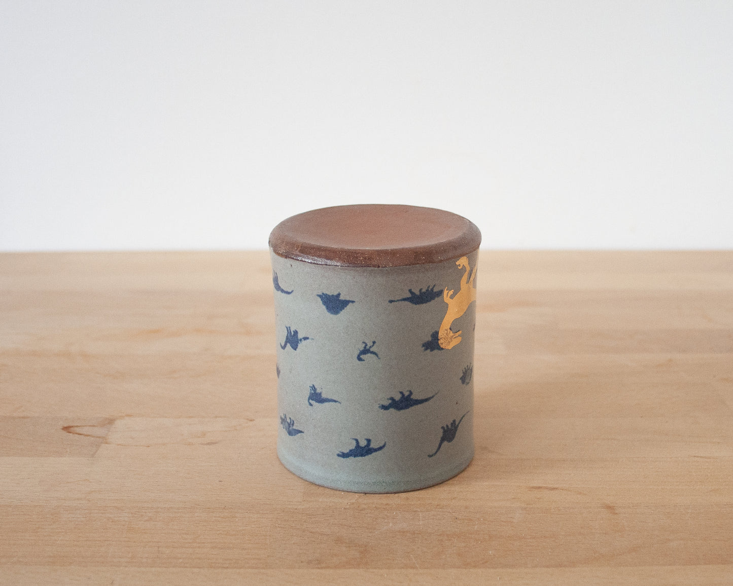 Gold Velociraptor Mug with small blue dinos
