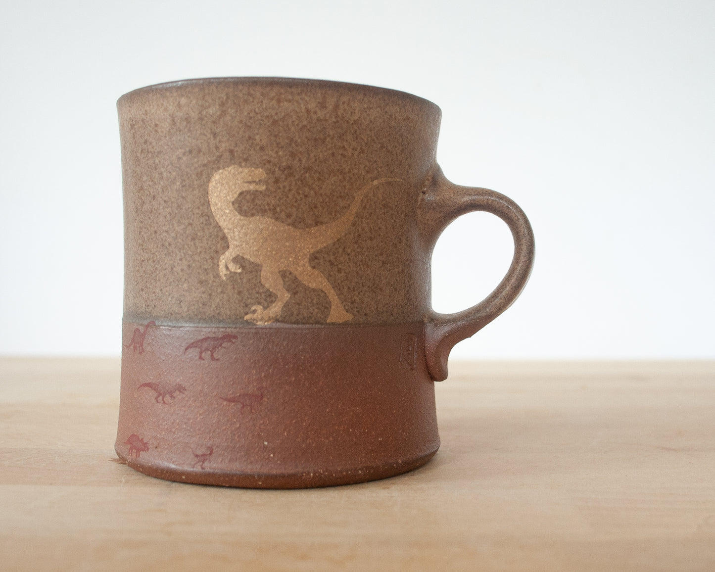 Gold Velociraptor Mug with matte brown glaze