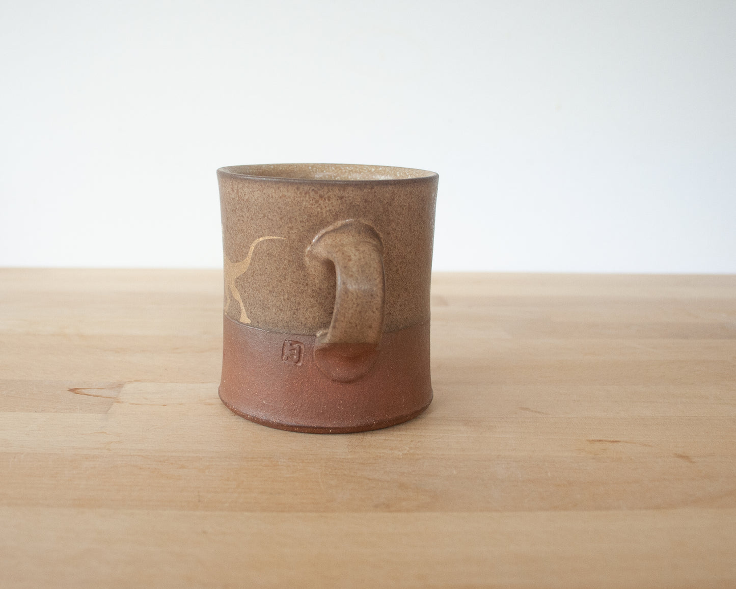 Gold Velociraptor Mug with matte brown glaze