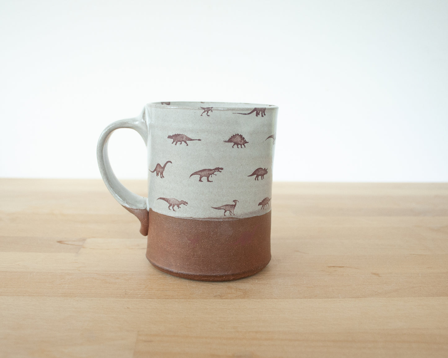 Gold Velociraptor mug with little dinosaurs