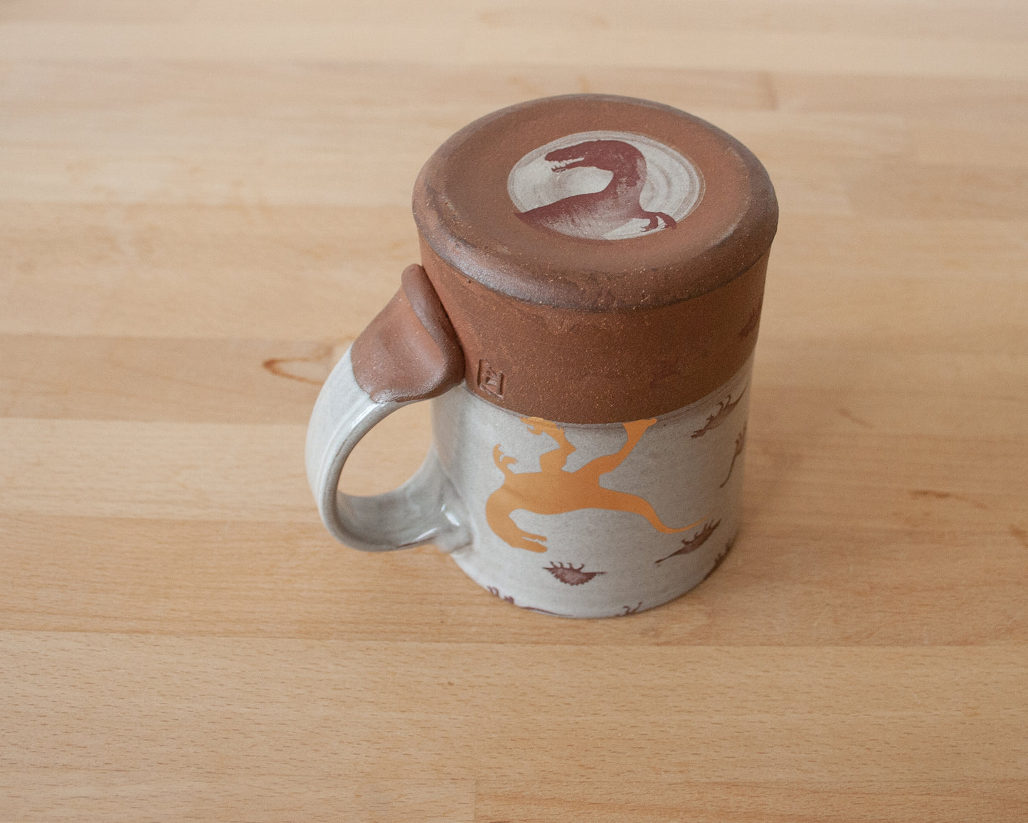 Gold Velociraptor mug with little dinosaurs