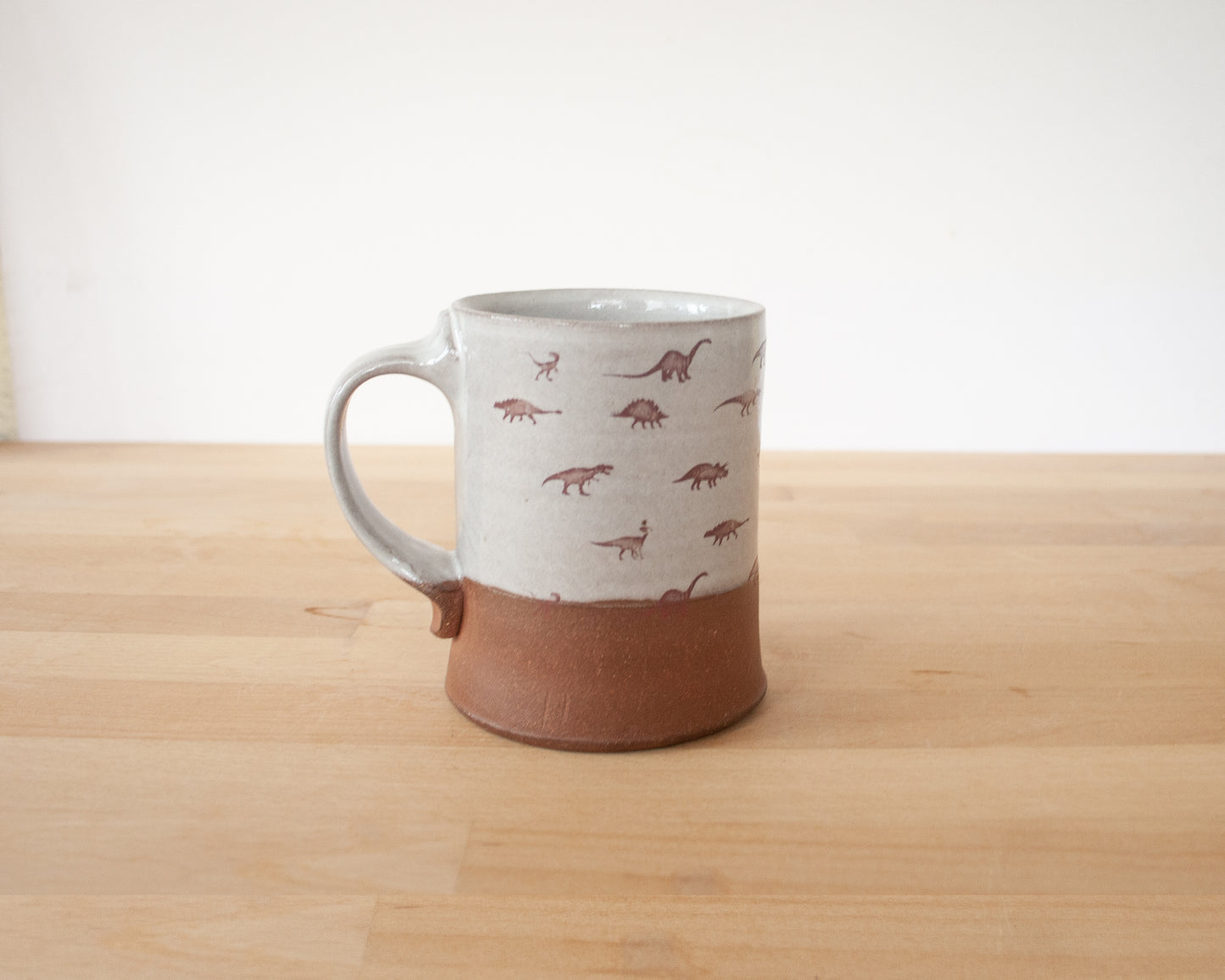 Gold Velociraptor mug with little dinosaurs