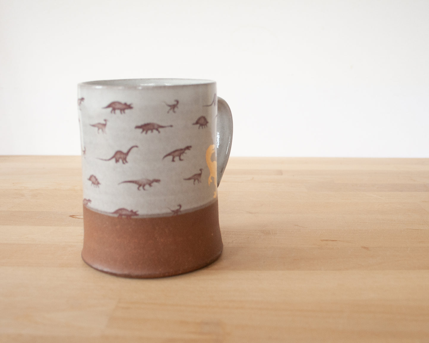 Gold Velociraptor mug with little dinosaurs