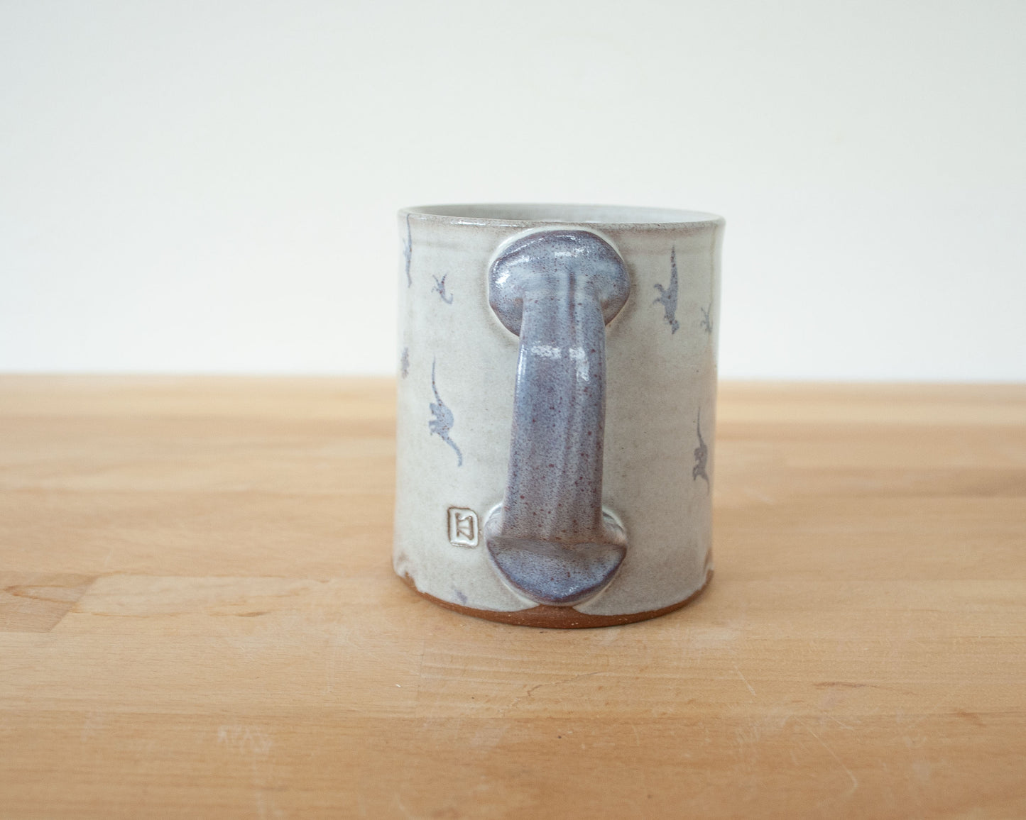 Mug with small purple dinosaurs