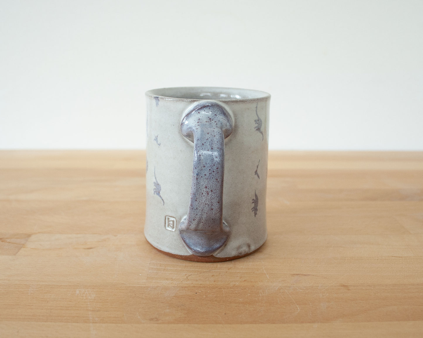 Mug with small purple dinosaurs