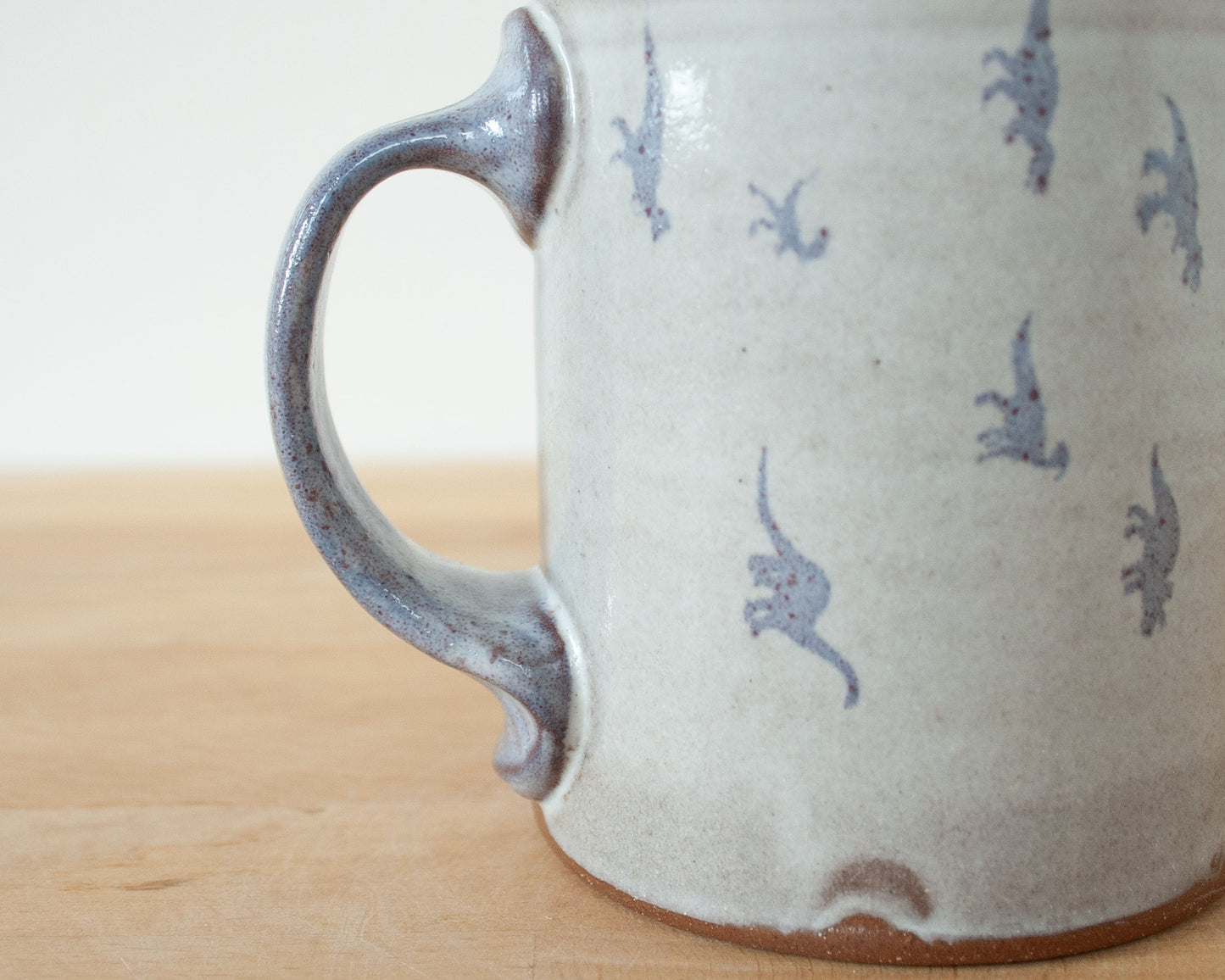 Mug with small purple dinosaurs