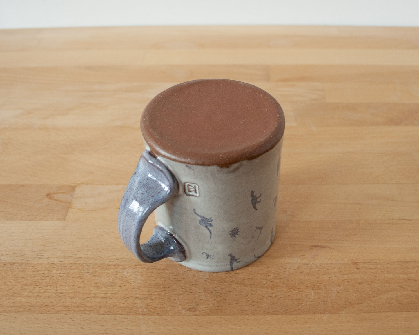 Mug with small purple dinosaurs