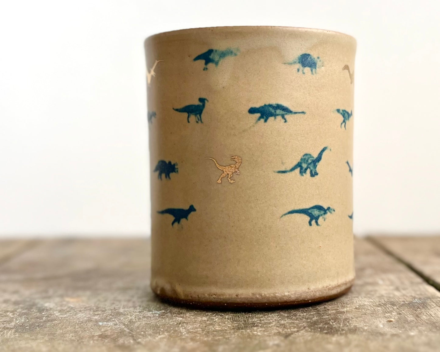 Mug with matte glaze and small blue and gold dinos