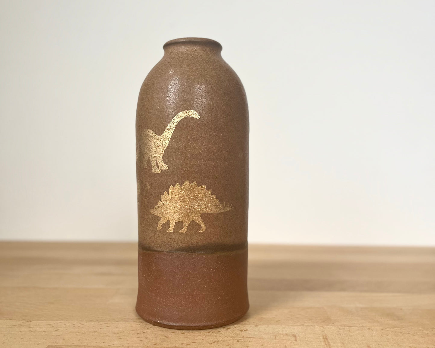 Vase with gold dinosaurs