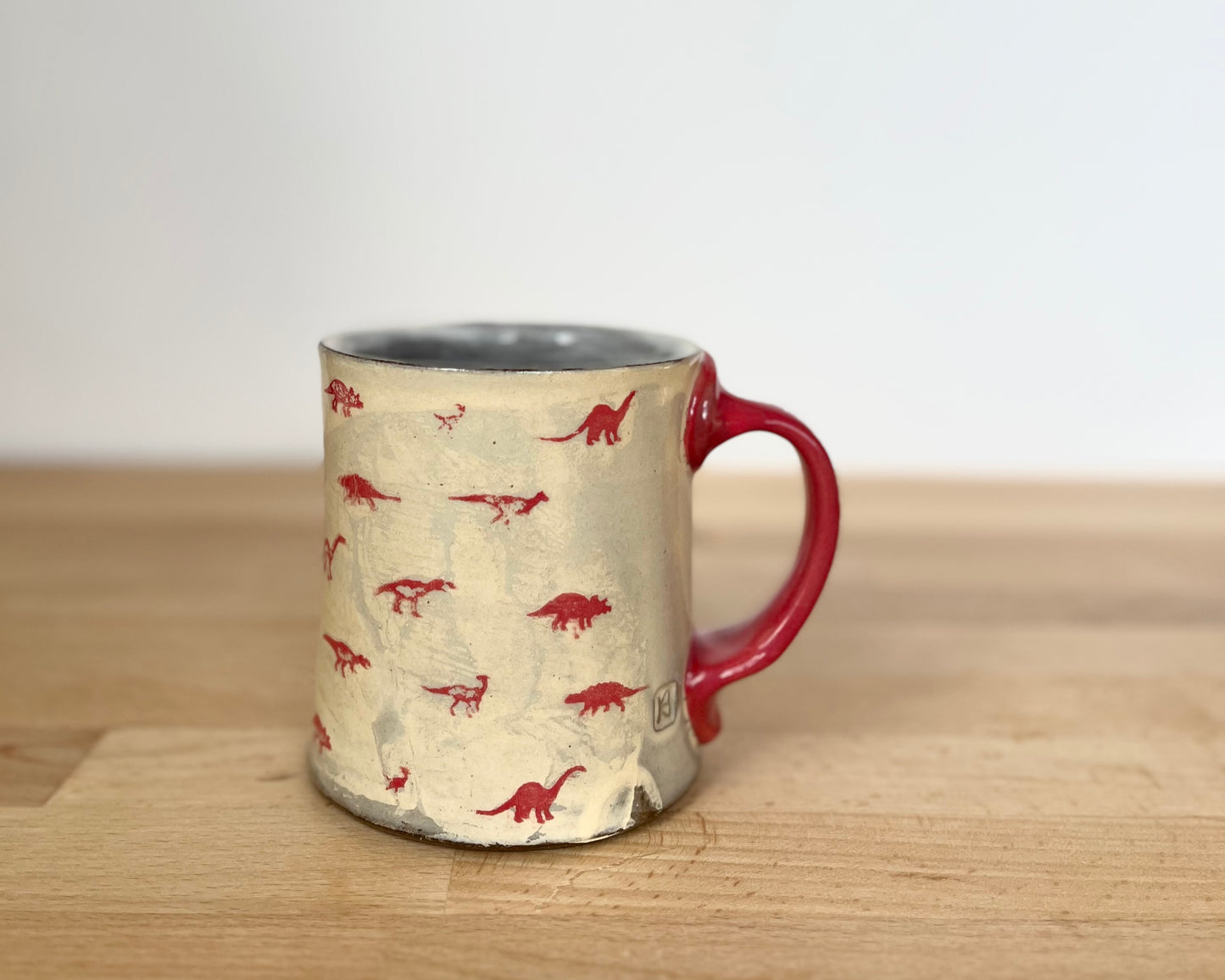 Mug with small red and gold dinos and gold T-Rex