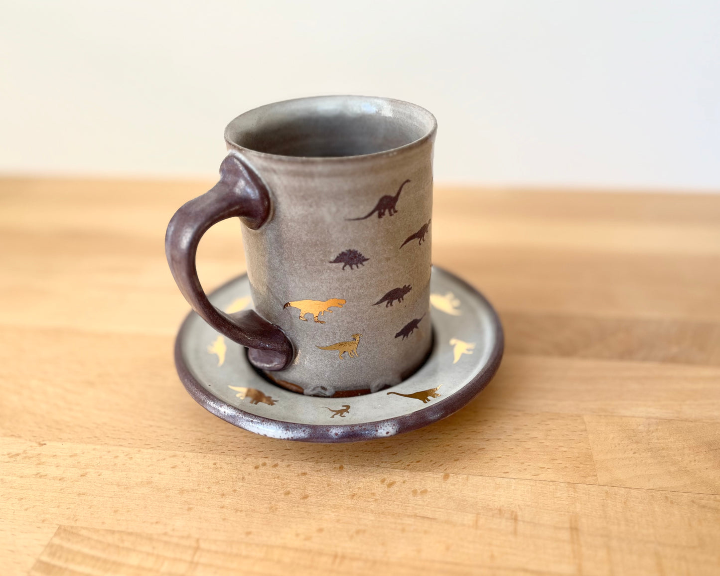 Mug and Saucer with purple and gold dinosaurs