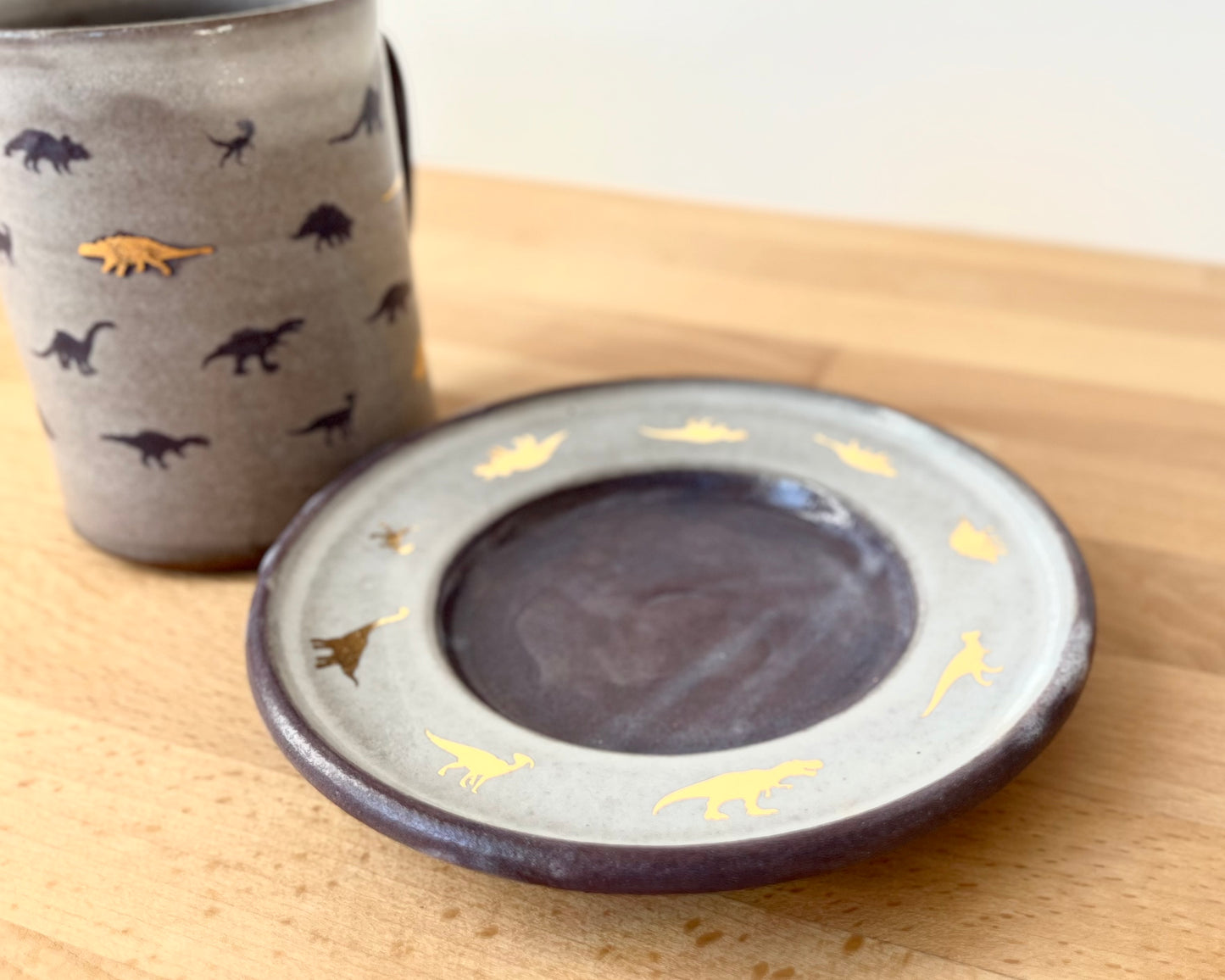 Mug and Saucer with purple and gold dinosaurs