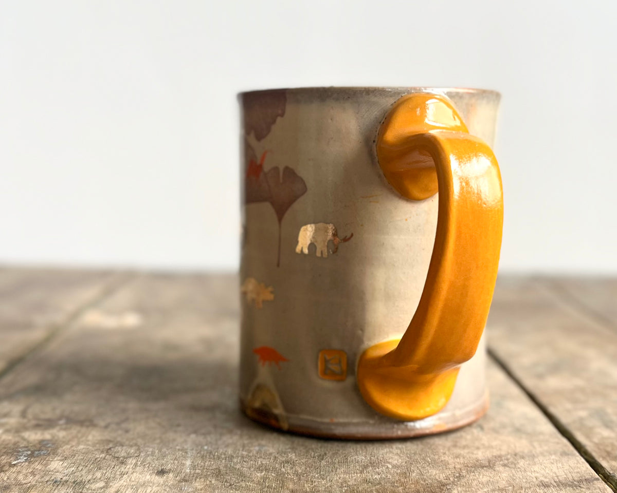 Mug with orange handle, gold decals and image transfer