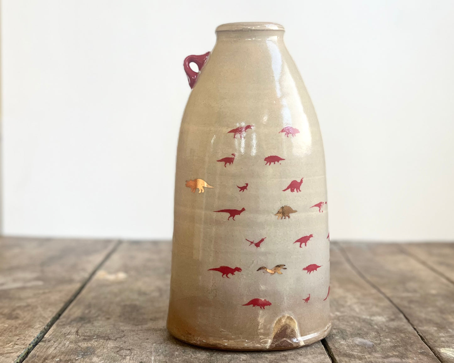 Flattened Vase with Red and Gold Dinosaurs