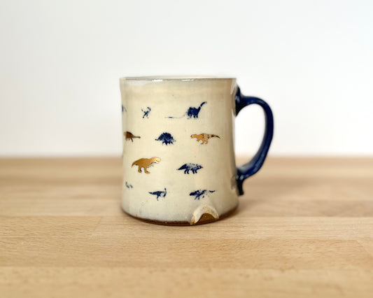 Mug with small blue and gold dinos