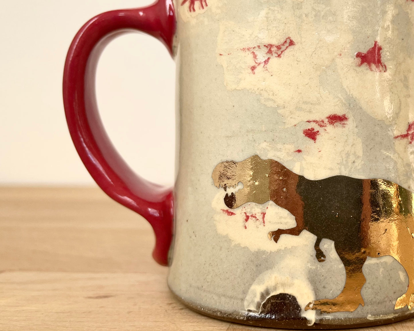 Mug with small red and gold dinos and gold T-Rex