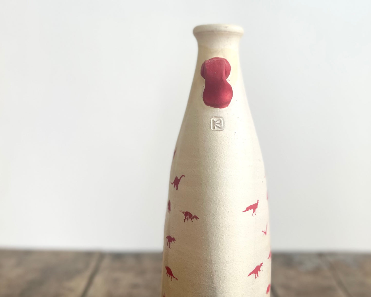 Flattened Vase with Red Dinosaurs
