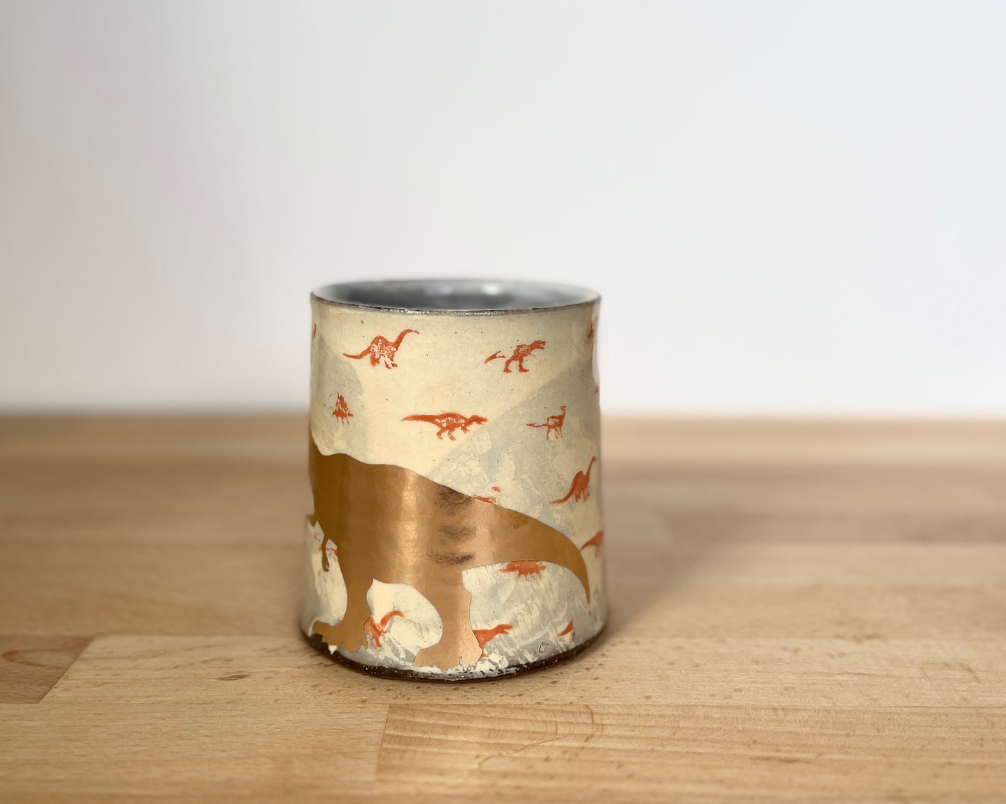 Mug with small orange and gold dinos and gold T-Rex