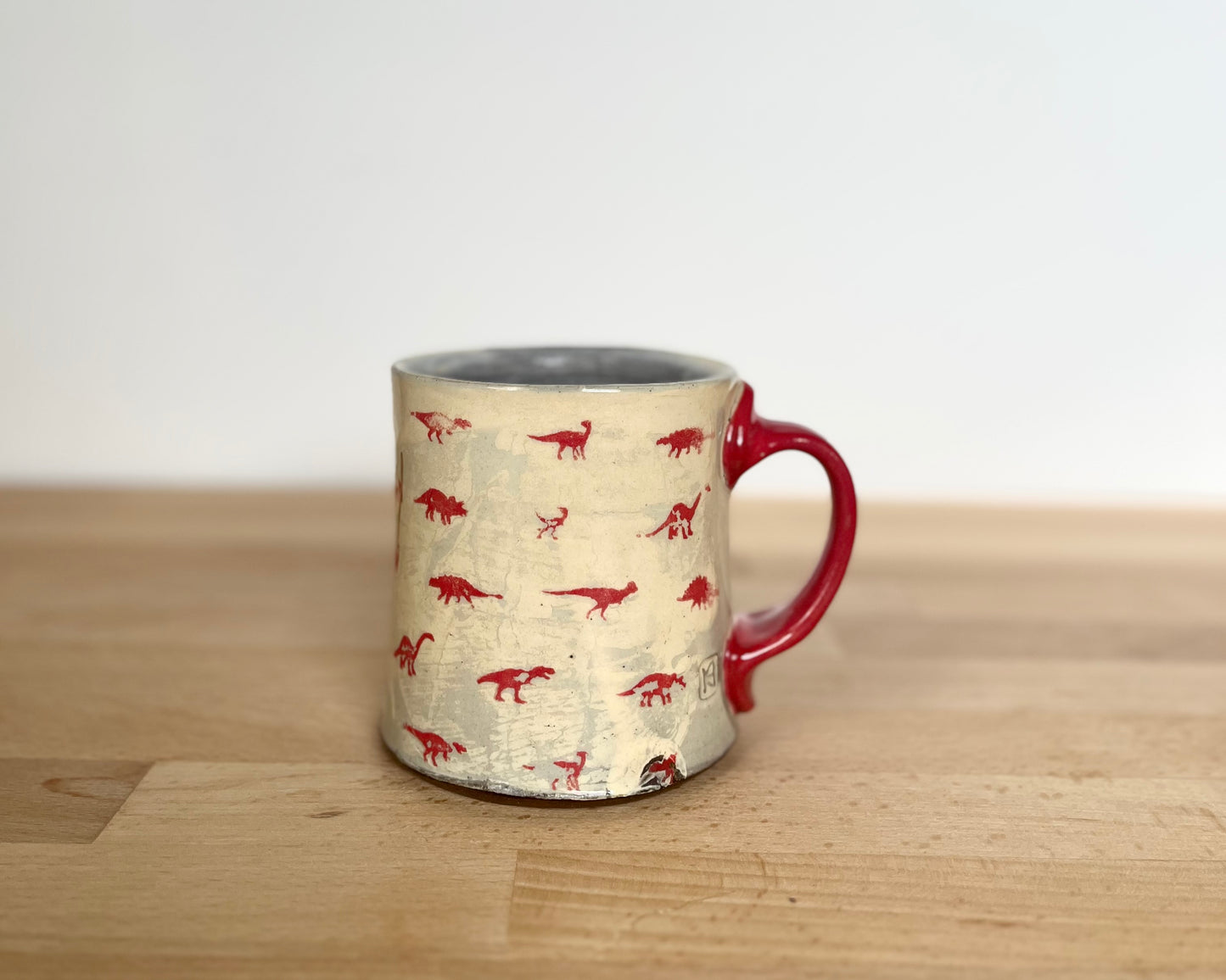 Mug with small red and gold dinos with Fibonacci spiral