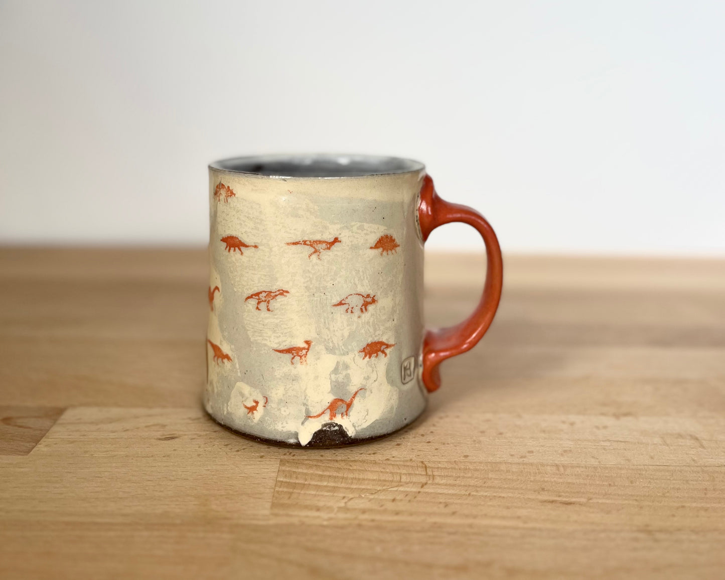 Mug with small orange and gold dinos and gold T-Rex