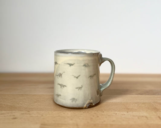 Mug with small grey-green dinos