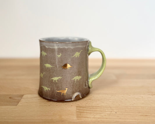 Mug with small green and gold dinos