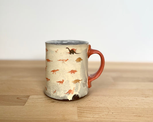 Mug with small orange and gold dinos