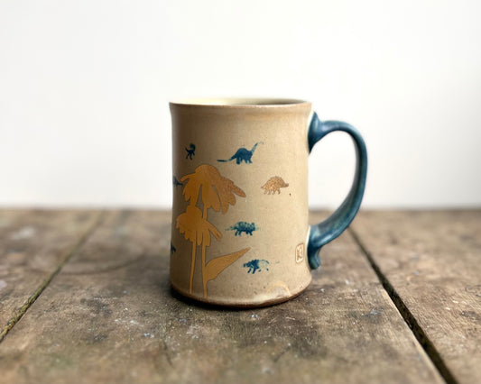 Mug with matte glaze and small blue and gold dinos