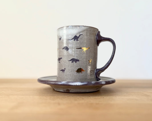 Mug and Saucer with purple and gold dinosaurs