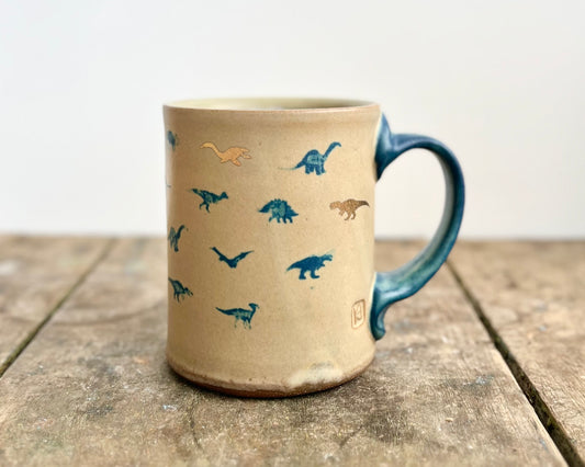 Mug with matte glaze and small blue and gold dinos
