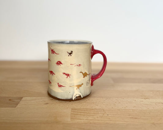 Mug with small red and gold dinos