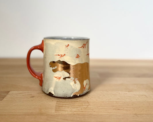 Mug with small orange and gold dinos and gold T-Rex