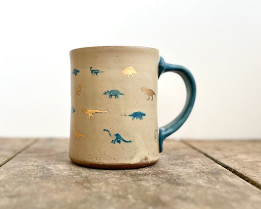 Mug with matte glaze and small blue and gold dinos