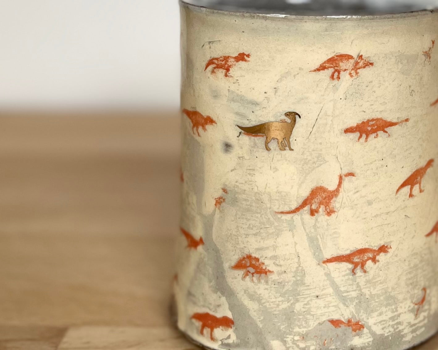 Mug with small orange and gold dinos