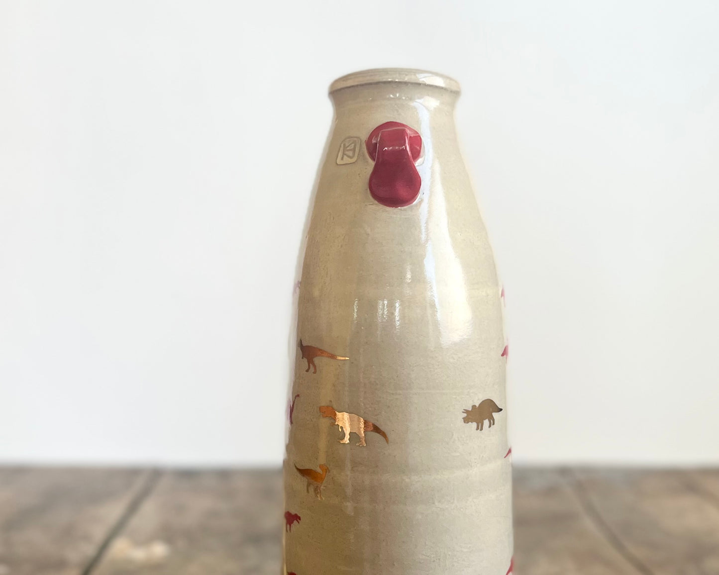 Flattened Vase with Red and Gold Dinosaurs