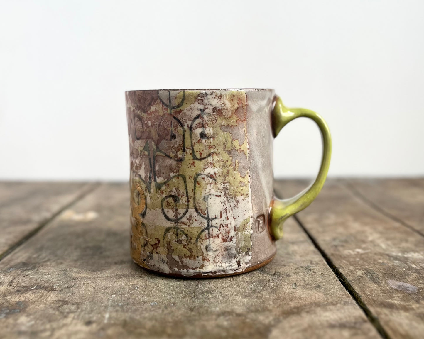 Mug with slip, gold decals and image transfer