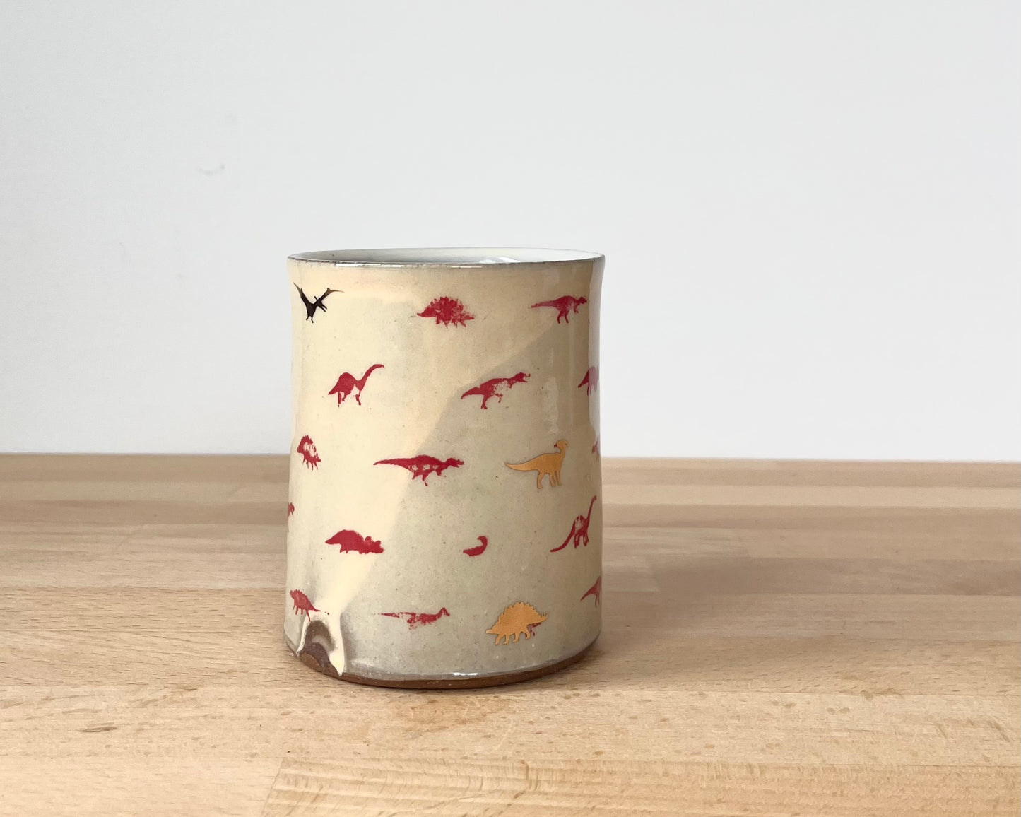 Mug with small red and gold dinos