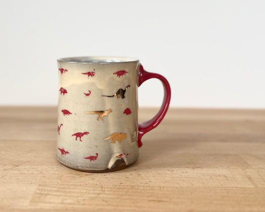 Mug with small red and gold dinos