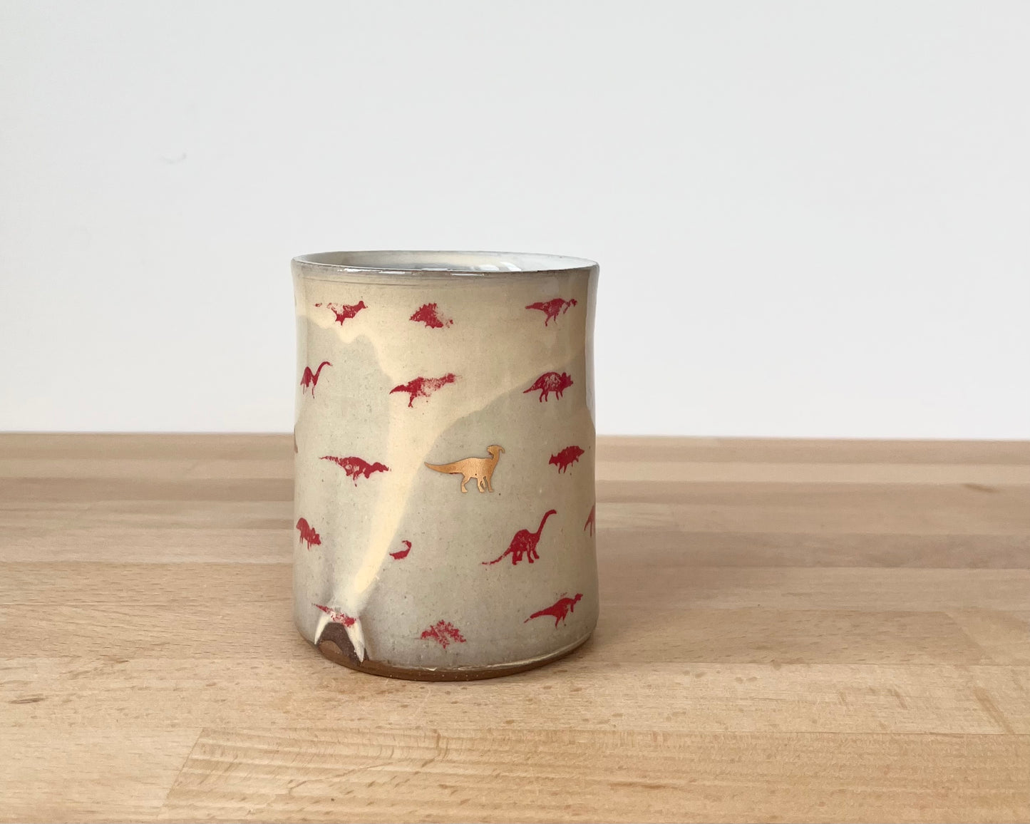 Mug with small red and gold dinos